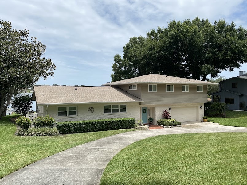 Beautifully maintained Florida lakeside home with manicured lawn
